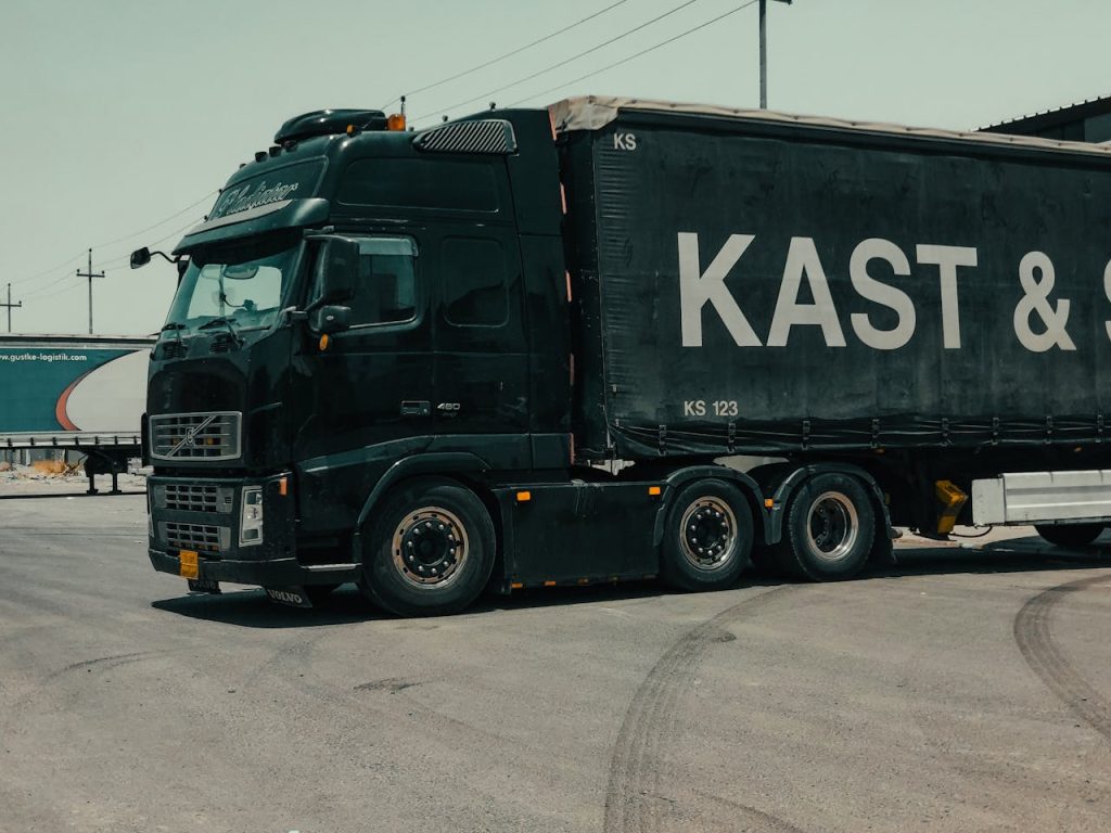A large industrial truck parked in an urban setting, showcasing transportation industry visuals.